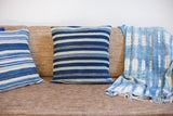 Textured African indigo textile with light blue resist-dyed patterns.