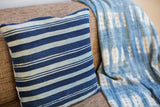 Vintage African indigo throw pillow, handwoven with thick dark and light blue stripes.