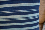 Finely handwoven vintage indigo pillow with thick alternating dark and light blue stripes.