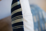 Vintage indigo striped textile with natural cotton canvas backing and enclosure stitching.