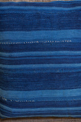 Dark blue indigo pillow featuring varied stripes, handwoven texture, and subtle character.