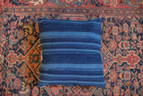Dark blue indigo throw pillow with strong, thick striped pattern and finely woven texture.