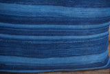 Finely woven dark indigo lumbar pillow texture, featuring prominent blue stripes and subtle age.