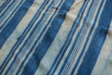 Vintage hand-dyed indigo and light blue striped cotton textile.