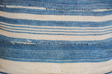 Finely woven striped indigo fabric with subtle blue tones and visible mending.