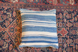 Light indigo and ivory striped pillow displaying varied texture and hand-spun cotton.