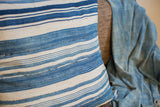 Vintage African indigo pillow detailed with light blue and ivory striped, textured weave.