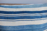 Handwoven vintage indigo striped textile with light blue and ivory, showing natural texture and storied wear.