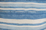 Visible hand-stitched repairs on light indigo and ivory striped pillow.