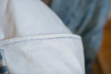 Pillow detail of off-white cotton canvas backing with double color stitch.