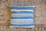 Varied light indigo and ivory stripes with handwoven texture on the vintage pillow.
