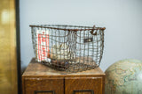 Aged wire mesh and original metal number tag on the mid-century industrial locker basket.