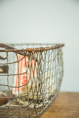 Vintage gym locker wire basket's rusted mesh with characterful, uneven wire weaving.