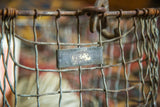 Vintage American Wire Form Co. metal tag with number 620 on wire basket.