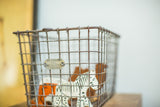 Detail of the vintage Fred Medart wire basket with original '21' number tag and silvery patina.