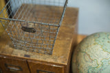Vintage Fred Medart wire basket featuring its unique irregular wire grid and original metal number tag.