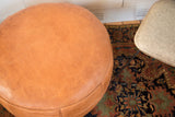 Decorative flower fan stenciling detail on the camel brown leather pouf.