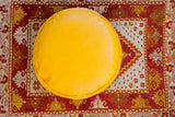 Antique Revival Leather Moroccan Pouf Ottoman, bright Fly Yellow with stenciled flower fan motifs.