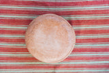 Nude leather pouf top with lightly distressed texture and fleur de lis stenciling.