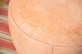 Nude leather Moroccan pouf with embossed flower fan motifs and subtle texture.
