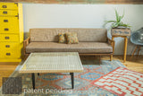 Wooden Mod Square Table styled as a coffee table in a mid-century modern living room.
