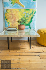 Handmade square mod coffee table with a glass top, slatted wood detail, and dark tapered legs.
