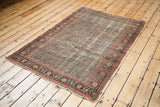 Intricate allover boteh design and distressed texture on this antique Senneh Persian rug.