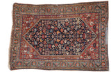 Antique Qashqai hand-knotted rug with a deep navy field and brilliant jewel-tone floral patterns, 4'6