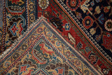 Antique Qashqai rug folded corner, revealing dense hand-knotted tribal patterns and a rich jewel-tone palette.