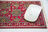 Red Star Ushak mouse pad, rich geometric pattern, with a white computer mouse.
