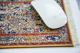 Persian Oriental mouse pad featuring intricate Soumac style animal life motifs and fringes.