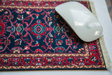 Deep indigo blue Turkish rug mouse pad with classic red vine pattern and a white mouse.