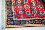 Pashmina Flowers mouse pad corner, red Herati floral motifs, dark blue border, fringe.