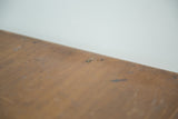 Close-up of antique Eureka silk spool cabinet's oak wood surface with scratches and patina.