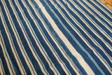 Hand woven African indigo textile with nuanced blue and cream stripes.