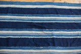 Collectible hand woven vintage textile with varied indigo blue and off-white stripes.