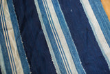 Collectible vintage indigo blue textile with visible hand woven striped panel joins.