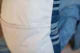 Pillow detail: striped indigo textile meeting cream canvas back with unique double color stitch.