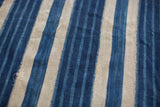 Vintage African hand-woven indigo blue and natural cotton textile showing stripe variations.