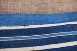 Close view of variegated indigo blue and natural white handwoven stripes.