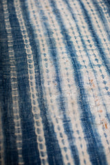 Hand-woven vintage African indigo throw with rich blue striped and dotted patterns.