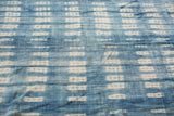 Hand woven vintage African indigo textile with denim blue and white resist-dyed patterns.