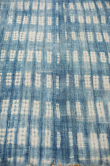 Collectible hand-woven African indigo textile showing stitched panels and blue and white resist patterns.