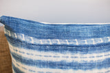 Faded indigo blue pillow fabric with rustic handwoven texture and white Batik pattern.