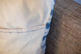 Pillow's cotton canvas back, showing the envelope enclosure and dark dotted stitch.