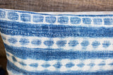 Textured handwoven fabric with faded indigo blue and white geometric Batik design.