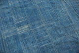 Hand woven indigo collectible textile with rich denim blue and subtle faded texture.