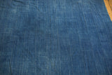 Textured vintage indigo batik textile, featuring subtle hand-dyed vertical striping.