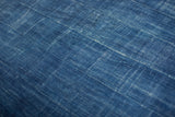Collectible hand-woven indigo cotton textile showcasing rich texture and subtle dye variations.