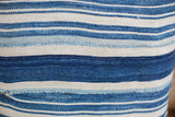 Finely woven striped indigo textile with varied blue tones and visible mending.